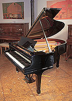 Rebuilt 1928, Steinway Model M grand piano for sale with a black case and spade legs. Piano has an eighty-eight note keyboard and a two-pedal lyre. 