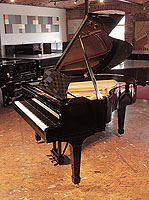 Rebuilt, 1956, Steinway Model M grand piano for sale with a black case and spade legs. Piano has an eighty-eight note keyboard and a two-pedal lyre.     