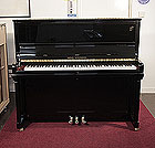 Piano for sale. A Brand new, Wilh Steinberg Model AT-K30 upright piano with a black case and brass fittings.
