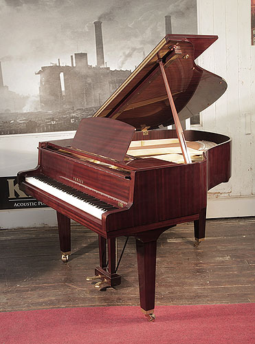 Reconditioned, 1974, Yamaha G1 baby grand piano with a mahogany case and square, tapered legs. Piano has an eighty-eight note keyboard and a two-pedal lyre. 