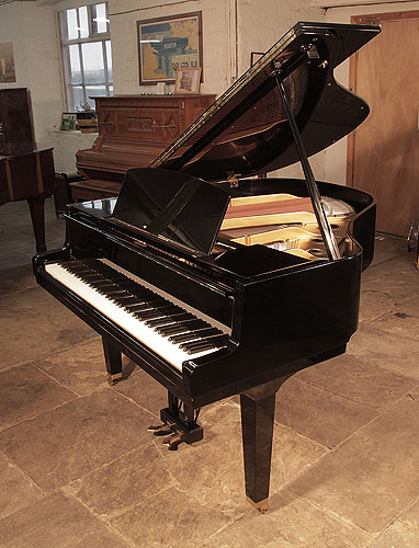Reconditioned, 1973, Yamaha G1 baby grand piano for sale with a black case and square, tapered legs Piano has an eighty-eight note keyboard and a two-pedal lyre.. 
