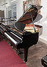 Piano for sale. A 1990, Yamaha G1 baby grand piano for sale with a black case and spade legs. Piano has an eighty-eight note keyboard and a three-pedal lyre.
