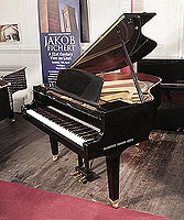 Reconditioned, 1988, Yamaha GH1 baby grand piano for sale with a black case and square, tapered legs. Piano has an eighty-eight note keyboard and a three-pedal lyre