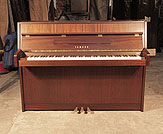 Piano for sale. Yamaha MP70N upright piano with a mahogany case and fitted silent system. Piano has an eighty-eight note keyboard and three pedals. 