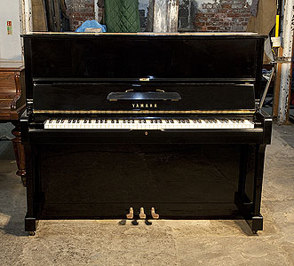 Reconditioned,   1974, Yamaha U1 upright piano with a black case and polyester finish. Piano has an eighty-eight note keyboard and three pedals.