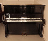 Piano for sale.  A 1961, Yamaha U2 upright piano with a black case and brass fittings. Piano has an eighty-eight note keyboard and two pedals. 