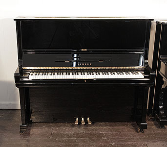 A 1980, Yamaha U3 upright piano for sale with a black case and brass fittings. Piano has an eighty-eight note keyboard and three pedals.  