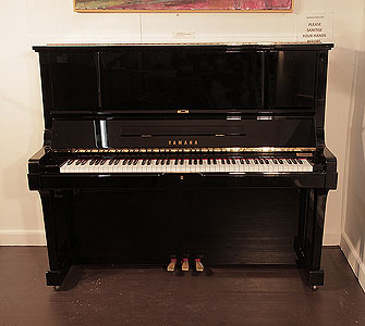 Reconditioned,  1987, Yamaha UX-3 upright piano for sale with a black case and brass fittings. Piano has an eighty-eight note keyboard and three pedals