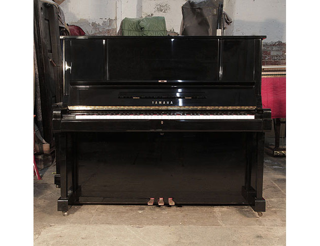 Reconditioned, 1982, Yamaha YUX upright piano for sale with a black case and brass fittings. Piano has an eighty-eight note keyboard and three pedals.  