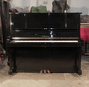 A 1982, Yamaha YUX upright piano for sale with a black case and brass fittings. Piano has an eighty-eight note keyboard and three pedals.   