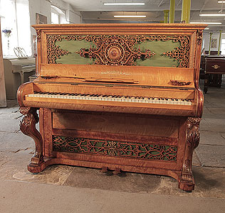 An 1855c, Brinsmead upright piano with a birch case and carved cabriole legs. Cabinet features intricate, fretwork front panels. Formerly the property of English music hall performer and male impersonator, Vesta Tilley 