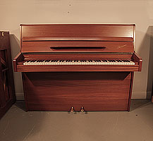 Danemann upright piano with a polished, mahogany case