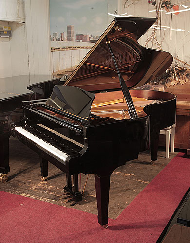Piano for sale. A 2010, Kawai RX-5 grand piano for sale with a black case and spade legs