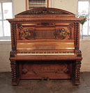 Piano for sale. German Late Renaissance style, Pfaffe upright piano for sale with a walnut case, mock roll top piano fall and barley twist legs