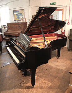 A 1975, Steinway Model B Steinway Model B grand piano for sale with a black case and spade legs Piano has a three-pedal lyre and an eighty-eight note keyboard.
