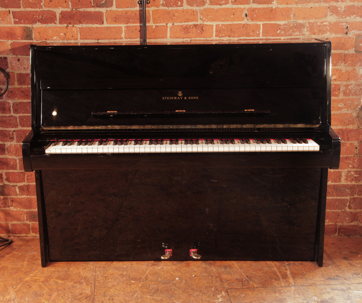 Steinway model Z upright piano for sale with a black case and brass