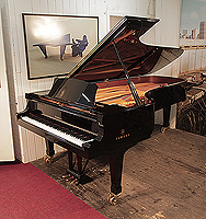 Reconditioned, 2009, Yamaha CFIII concert grand piano for sale with a black case and dual casters. Piano has an eighty-eight note keyboard and a three-pedal lyre.
