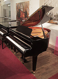 Reconditioned, 2009, Yamaha GB1 baby grand piano for sale with a black case and square, tapered legs