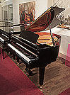 Piano for sale. A 1978, Yamaha G2 grand piano for sale with a black case and spade legs.  Piano has an eighty-eight note keyboard and a three-pedal lyre.