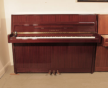  Reconditioned, 1988, Yamaha M108 upright piano with a mahogany case and brass fittings