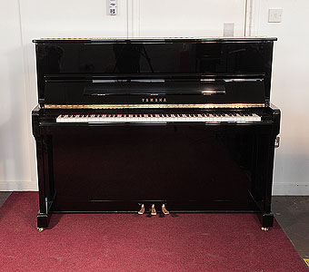  Reconditioned,  2007, Yamaha P121G upright piano for sale with a black case and brass fittings