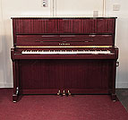 Piano for sale. Reconditioned, 2001, Yamaha P121N upright piano with a mahogany case and brass fittings. Piano has an eighty-eight note keyboard and three pedals.  