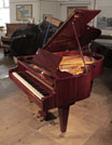 Piano for sale. Restored, Bosendorfer grand piano for sale with a mahogany case and square, tapered legs. Piano has an eighty-eight note keyboard and a two-pedal lyre..