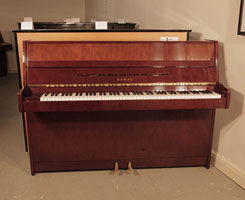 Reconditioned, 1985, Kawai CX-4S Upright Piano For Sale with a Walnut Case and Brass Fittings. Piano has an eighty-eight note keyboard and two pedals. 