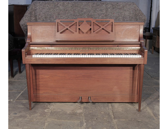 Pre-owned, 1970, Knight upright piano with a mahogany case and cut-out music desk. Piano has an eighty-eight note keyboard and two pedals.. 