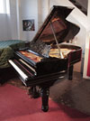 Piano for sale.  Rebuilt, 1883, Steinway Model A grand piano for sale with a black case, filigree music desk and fluted, barrel legs. Piano has an eighty-eight note keyboard and a three-pedal lyre. 