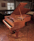 Reconditioned, 1900, Steinway Model B grand piano for sale with a satinwood case and spade legs. Entire cabinet inlaid with boxwood stringing accents. Piano has an eighty-eight note keyboard and a three-pedal lyre.