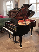 Toyama TC-187 grand piano for sale with a black case and spade legs. Piano features a slow fall mechanism on the keyboard lid. Piano has an eighty-eight note keyboard and a three-pedal lyre..