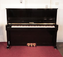 Piano for sale. Reconditioned, Wendl and Lung upright piano for sale with a black case and brass fittings. Piano has an eighty-eight note keyboard and three pedals. 