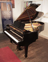 A 1984, Yamaha G5 grand piano for sale with a black case and spade legs 
