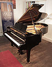 Piano for sale. A 1984, Yamaha G5 grand piano for sale with a black case and spade legs