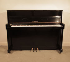 Reconditioned, 1972, Yamaha LX-110 upright piano for sale with a black case and brass fittings. Piano has an eighty-eight note keyboard and three pedals. 