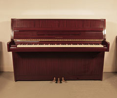 A 1984, Yamaha M5JR upright piano for sale with a mahogany case and brass fittings . Piano has an eighty-eight note keyboard and three pedals.   