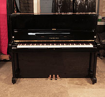 A 1971, Yamaha U1 upright piano with a black case and polyester finish