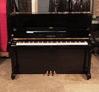 Piano for sale. A 1971, Yamaha U1 upright piano with a black case and polyester finish. Piano has an eighty-eight note keyboard and three pedals.