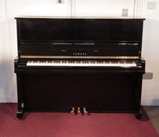 Reconditioned, 1990, Yamaha U10A upright piano with a black case and polyester finish. Piano has an eighty-eight note keyboard and three pedals.