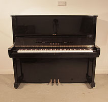 Reconditioned, Yamaha U5 upright piano with a black case and polyester finish. Piano has an eighty-eight note keyboard and three pedals.