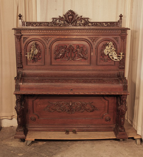 Neoclassical style, Francke upright piano for sale with an ornately carved, oak case and griffin legs. Cabinet features carved angels, lions heads, acanthus and openwork arcading.Piano has an eighty-five keyboard and two pedals. 