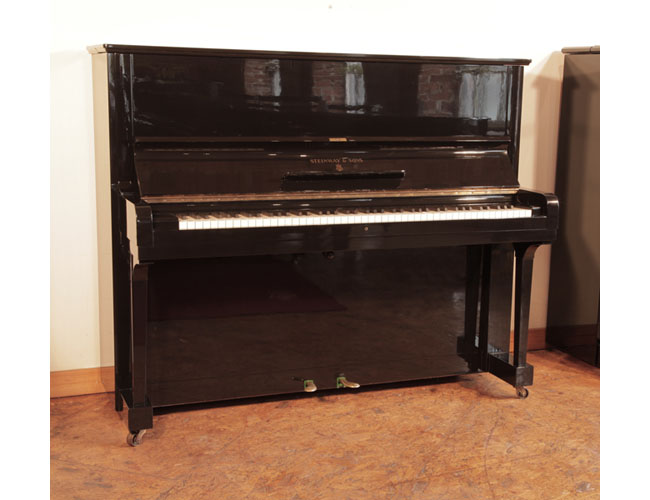 A 1939, Steinway Model V upright piano for sale with a black case and brass fittings. Piano has an eighty-eight note keyboard and two pedals 