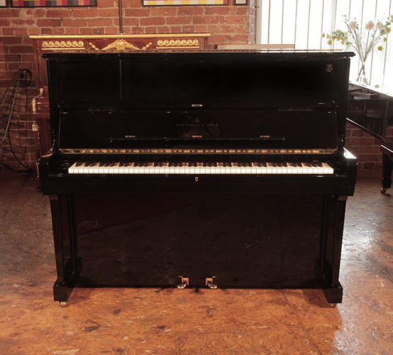 Reconditioned, 2002,Steinway Model V upright piano with a polished black case and brass fittings. Signed by Lang Lang.