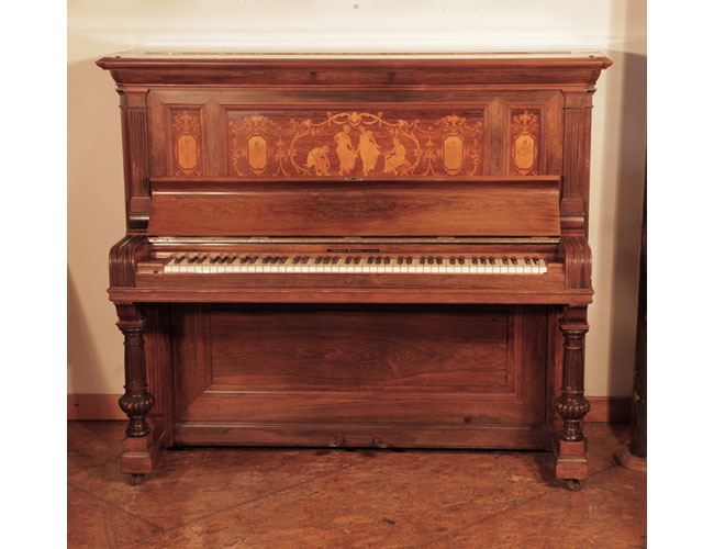 An 1894, Steinway upright piano for sale with a polished, rosewood case and panels inlaid in with dancing ladies and putti. Piano has an eighty-five note keyboard and two pedals 