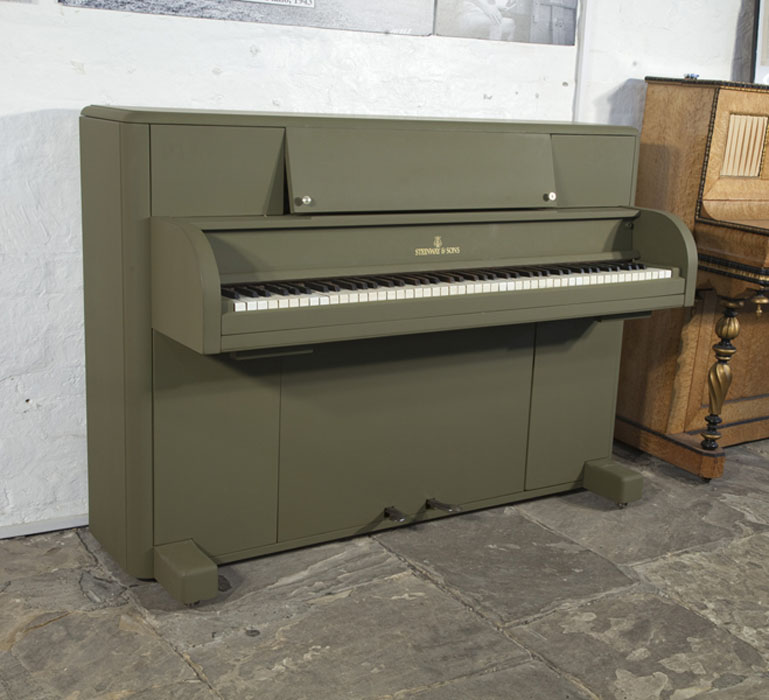 A 1944, Steinway 'Victory Vertical' G.I. upright piano for sale with an olive drab case. This upright was airdropped onto battlefields during WWII for the American troops. Piano has an eighty-eight note keyboard and two pedals. 