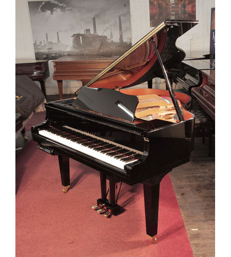 A 2014, Yamaha GB1 baby grand piano for sale with a black, gloss case and square, tapered legs. Piano has a fitted Disklavier DKC-800 player system. Piano has an eighty-eight note keyboard and a three-pedal lyre.