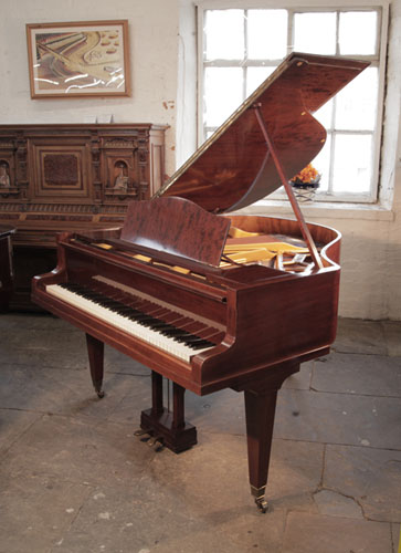 Reconditioned, 1934, Bluthner Model 10 baby grand piano with a figured, mahogany case and square, tapered legs.. Piano has an eighty-eight note keyboard and a two-pedal lyre. 