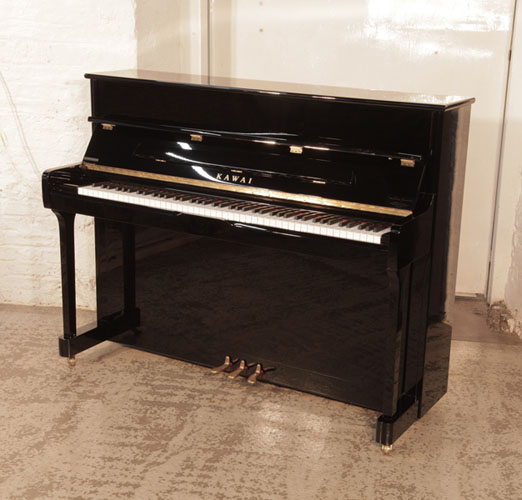 Piano for sale. As new, Kawai K-2 upright piano for sale with a black gloss case.  Piano has an eighty-eight note keyboard and three pedals.

