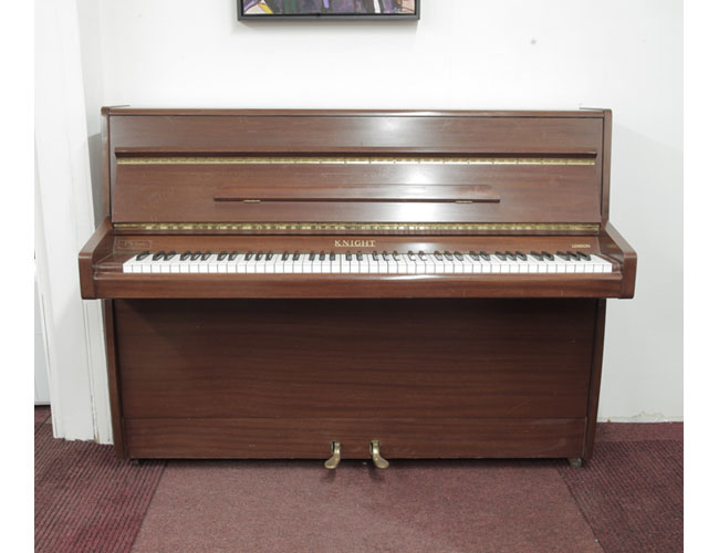 Pre-owned, 1970, Knight upright piano with a mahogany case. Piano has an eighty-eight note keyboard and two pedals 